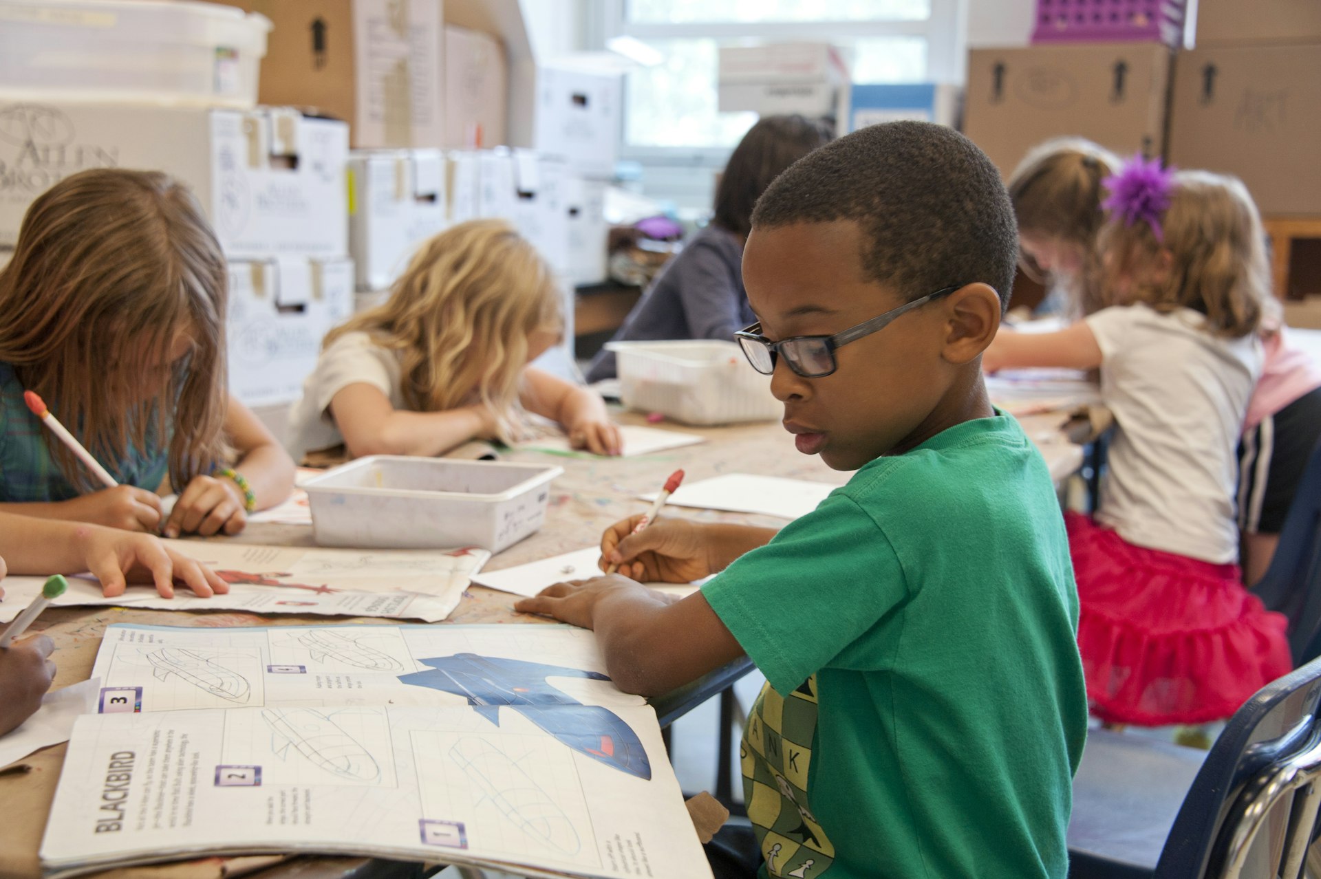 Enfants en classe travaillant sur des exercices adaptés